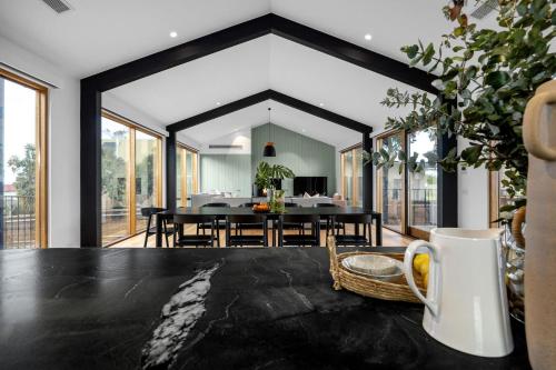 an open living room with a table and a dining room at Axbridge in Flinders