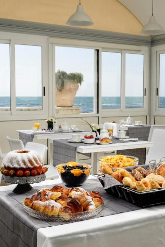a buffet with many different types of bread and pastries at Villa delle Palme in Santa Marinella