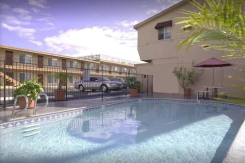 a large swimming pool in front of a building at Big 7 Motel in Chula Vista