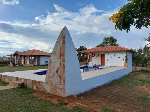 Cette chambre offre une vue sur une maison dotée d'un mur en pierre. dans l'établissement Casa de Campo EL LAGUITO - Mesa de los Santos, à Los Santos