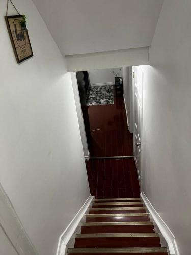 a hallway with a stairway leading up to a room at 1 bedroom with private entrance in Ajax