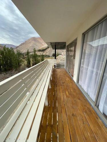 a white bench on a building with a view of the desert at Casa Montegrande in Monte Grande