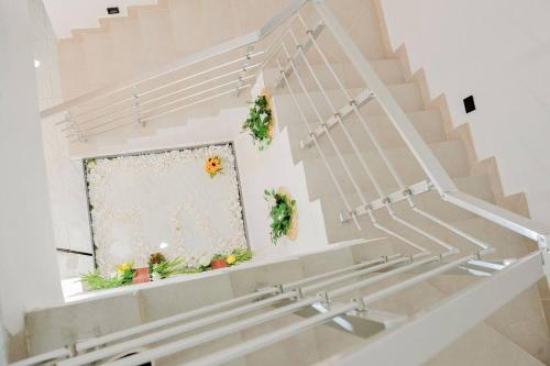 a staircase with potted plants and a window at Luxury 4bed Harris Drive Lekki in Lagos