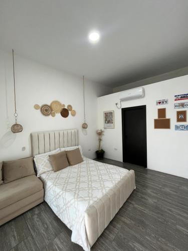 ein Schlafzimmer mit einem großen Bett und einem Sofa in der Unterkunft Casa en San Clemente con piscina in San Clemente