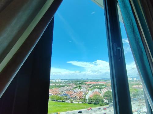 a view of a city from a window at Monstera Meritus Homestay - Penang Butterworth Prai 1-8PAX in Perai