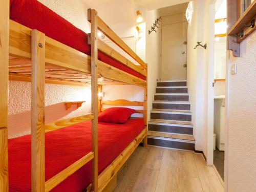 a bedroom with two bunk beds and a staircase at Studio Avoriaz, 1 pièce, 4 personnes - FR-1-314-170 in Morzine