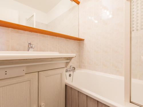 a bathroom with a tub and a sink and a shower at Studio Avoriaz, 1 pièce, 4 personnes - FR-1-314-170 in Morzine