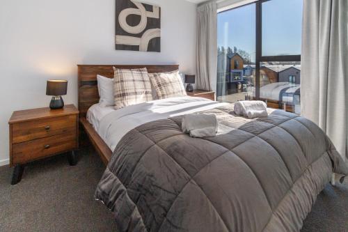 a bedroom with a large bed and a window at Vibrant Inner City Escape Near New Regent Street in Christchurch