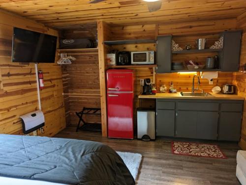 a kitchen with a red refrigerator in a cabin at Red Barn Retreat in North Fork