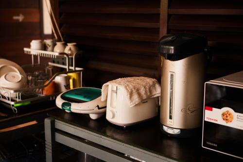 eine Arbeitsplatte mit einem Toaster und einem Toaster in der Unterkunft Chommuang Guest House in Phra Nakhon Si Ayutthaya