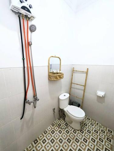 a bathroom with a toilet and a shower at Tropical oasis private home in Krambitan