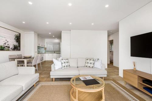 a living room with a couch and a tv at Beach Break in East Ballina