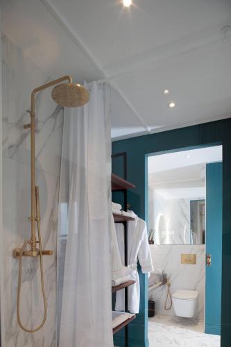 a bathroom with a shower with a shower curtain at The Townhouse in Udine