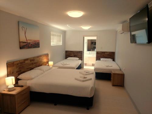 a hotel room with two beds and a television at Lake Tyrrell Accommodation LTA in Sea Lake