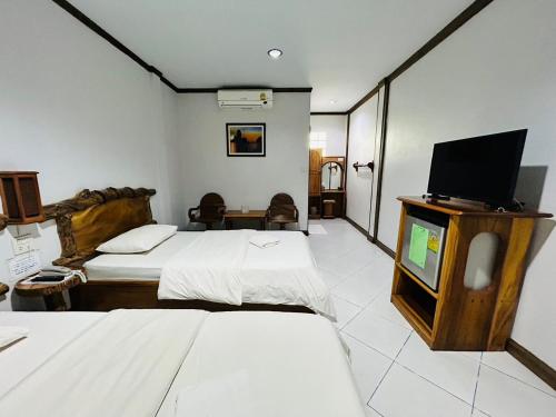 タークにあるMAGMAI HOMESTAY & TOWERのベッド2台、薄型テレビが備わるホテルルームです。