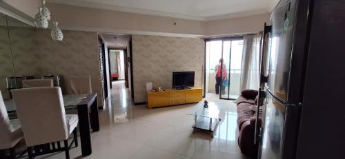 ein Wohnzimmer mit einem TV und einem Esszimmer in der Unterkunft Sudirman Tower Condominium in Jakarta