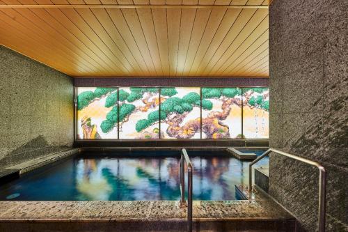 une piscine dans un bâtiment avec une carte sur le mur dans l'établissement Daiwa Roynet Hotel Nara Natural Hot Spring, à Nara