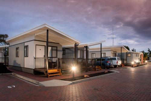 a house with a car parked in a parking lot at Breakfree Port Pirie in Port Pirie