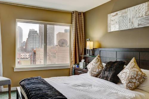 a bedroom with a bed and a large window at Modern Downtown Top Floor Penthouse With Bay Views in Seattle