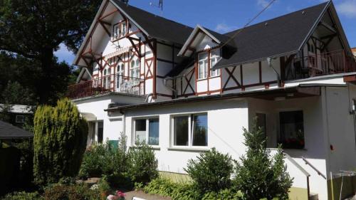 a large white house with a black roof at Heringsdorf, Residenz Inselliebe - EZ in Heringsdorf