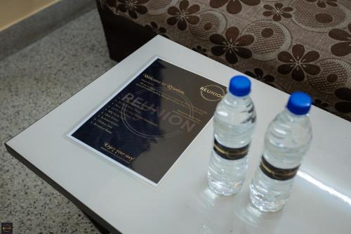 two bottles of water are sitting on a table at Reunion Regal Villa in Udupi