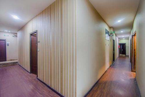 a hallway of an office building with wooden walls at Mg Guest House in Kolkata