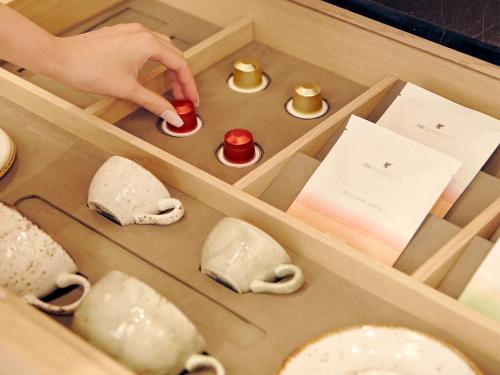 a person playing with a toy in a wooden box at JW Marriott Jeju Resort & Spa in Seogwipo