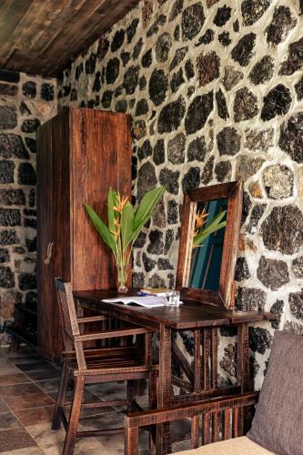 a wooden table with a mirror and a chair at ChezCao Rice Field Ecolodge Ninh Binh in Ninh Binh