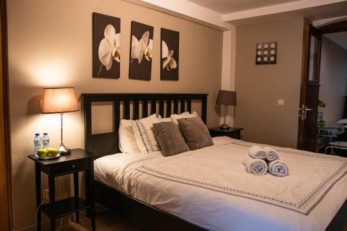 a bedroom with a bed with towels on it at Archimede Guest House in Brussels