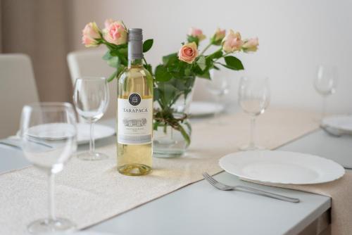 a bottle of wine sitting on a table with glasses at Prague - Karlin Apartments in Prague