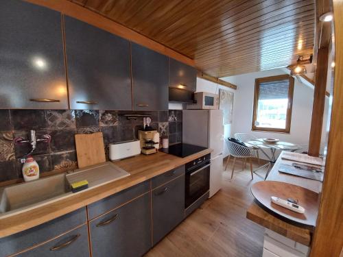 a kitchen with a sink and a counter top at Bátory Luxury Apartman in Békéscsaba