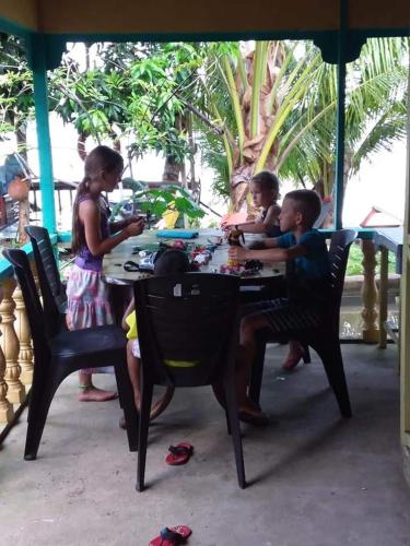 a group of people sitting at a table at Ella's Place Salang Tioman in Tioman Island