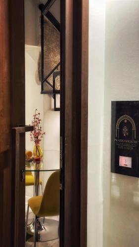a room with a table and a chair and a sign at Palazzo Maqueda in Palermo