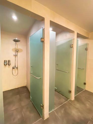 a room with two green doors in a building at d'primahotel Seminyak in Seminyak