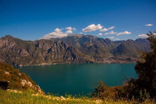 a view of a lake with mountains in the background at Italian Vacation Homes - Lucy's House in Parzanica