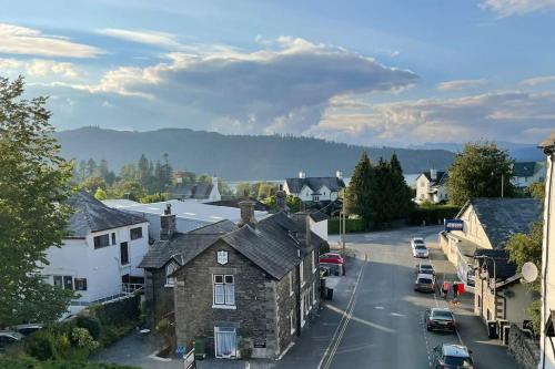 a small town with houses and a street with cars at Perfectly Located, Central Bowness Flat With Free Parking and Lake Views in Windermere