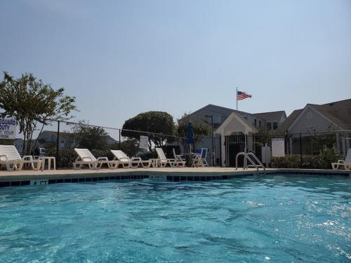a large swimming pool with chairs at 3B2FB Blissful Surfside Life a peaceful quiet getaway 25 years old and Up ONLY in Myrtle Beach
