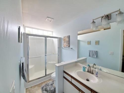 a bathroom with a sink and a toilet and a mirror at 3B2FB Blissful Surfside Life a peaceful quiet getaway 25 years old and Up ONLY in Myrtle Beach