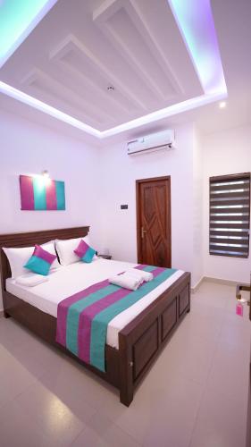 a bedroom with a large bed in a room at JAMUNA VILLA in Jaffna