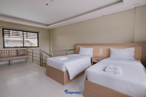 Un ou plusieurs lits dans un hébergement de l'établissement Tropicasa Hotel