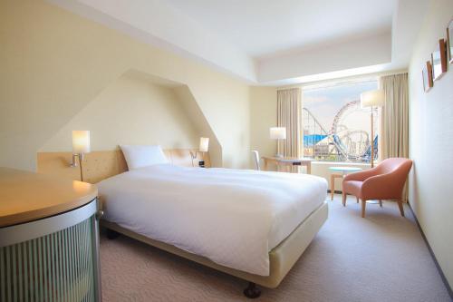 a hotel room with a large bed and a large window at Tokyo Dome Hotel in Tokyo