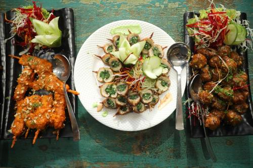 a plate of food with meat and vegetables on a table at HOTEL NAT GRAND REGENCY LUDHIANA Punjab INDIA in Ludhiana