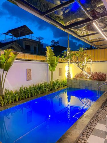 a pool in the middle of a building at night at Villa Sindang Restu Sr 19 Private Pool 4Br 15 Pax in Cianjur