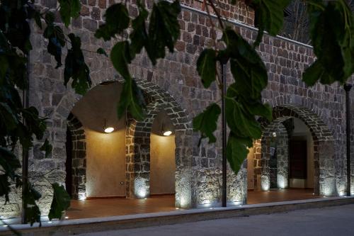 a row of arches on a brick wall with lights at Agriturismo ARCE di Monte Acero in Faicchio