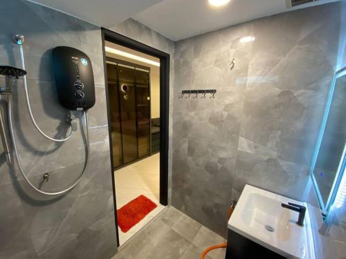 a bathroom with a shower and a sink and a mirror at Brand New Premium House & Karaoke @BM Near Iconcity in Bukit Mertajam