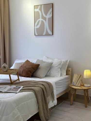 a white bedroom with a bed and a table at 10 min to My town family unit By Nexx Field in Kuala Lumpur