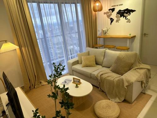 a living room with a couch and a table at 10 min to My town family unit By Nexx Field in Kuala Lumpur