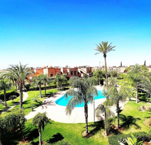 an overhead view of a pool with palm trees at Appart atlas resort in Marrakech