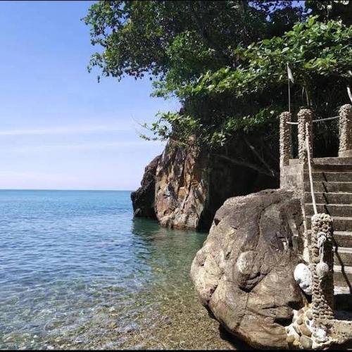 a staircase on a rock next to the water at Cliff View Bungalows in Ko Chang