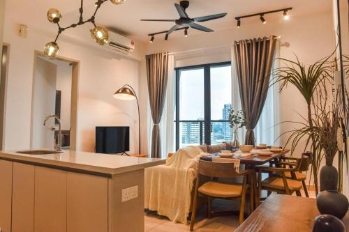 a kitchen and living room with a table and a dining room at 10 min to My town family unit By Nexx Field in Kuala Lumpur